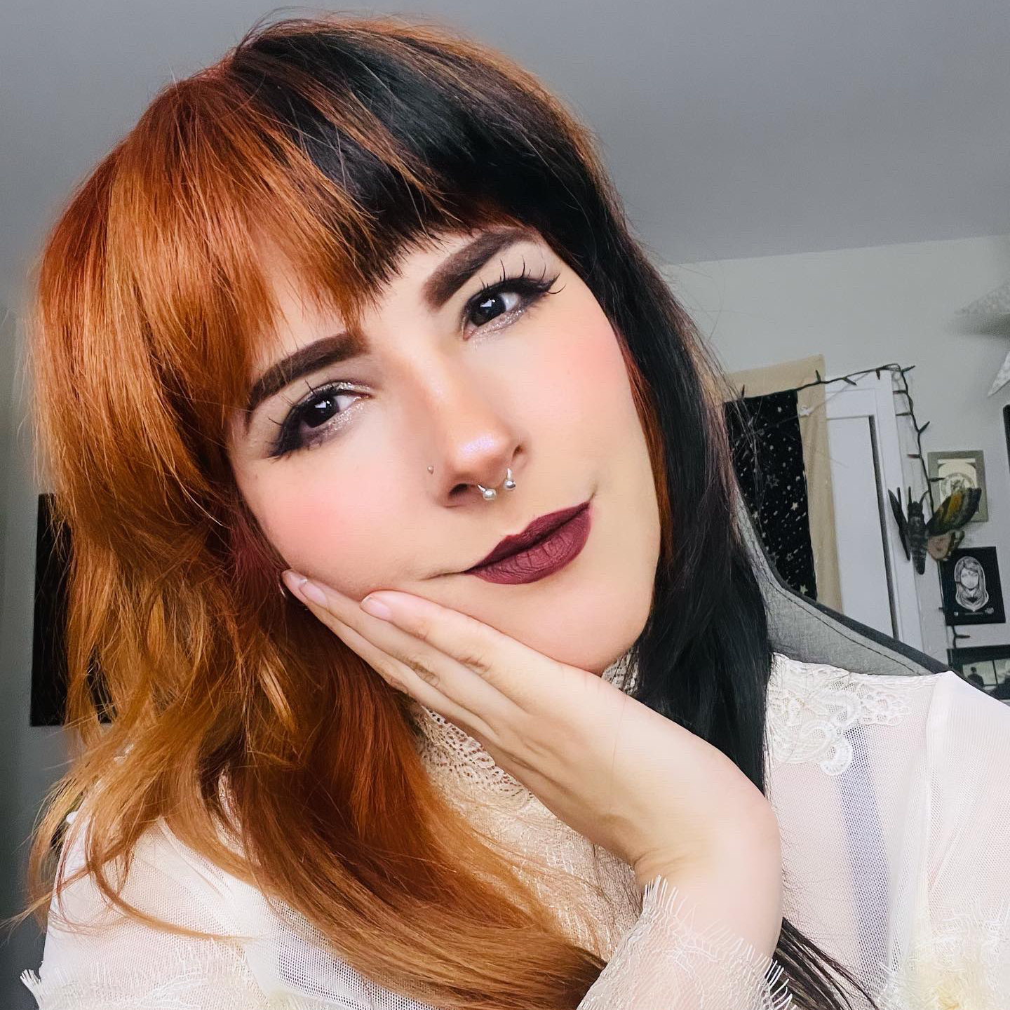 helveticat wearing a white top with half orange and half black hair